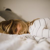 financial stress woman lying on bed