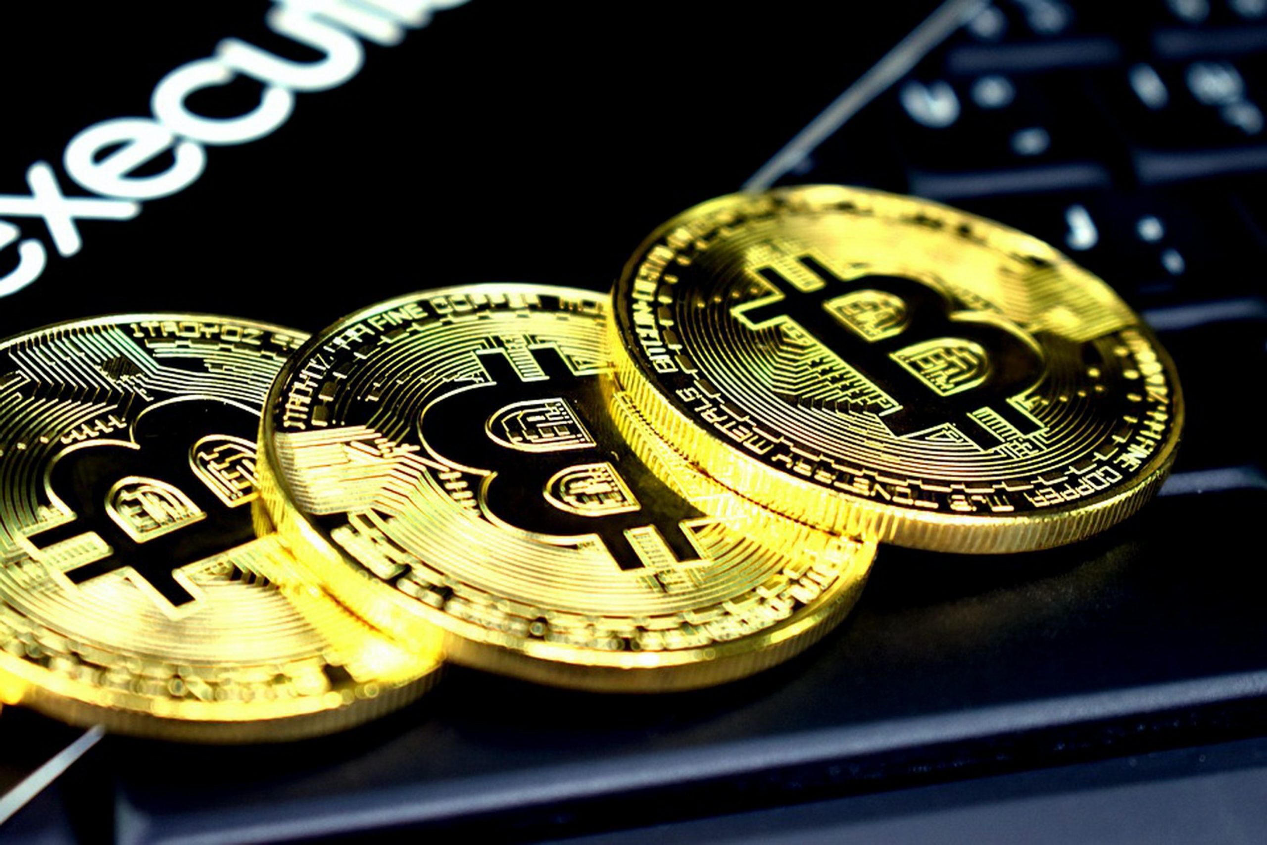 bitcoin three round gold-colored bitcoins