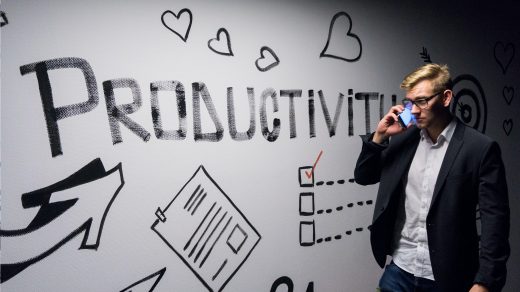 Entrepreneur needs man holding smartphone looking at productivity wall decor