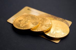 bitcoin three round gold-colored Bitcoin tokens