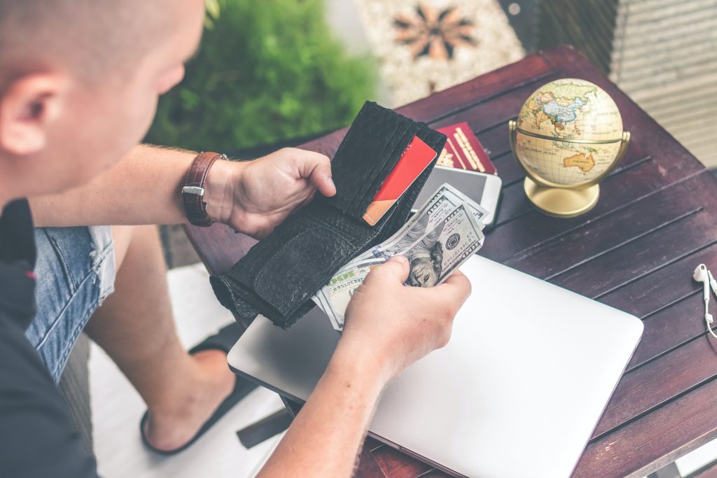 emergency loans person holding wallet and US dollar bills