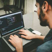 web programmers man programming using laptop