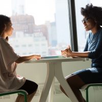 Job Interview two women sitting beside table and talking