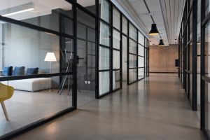 business office space hallway between glass-panel doors