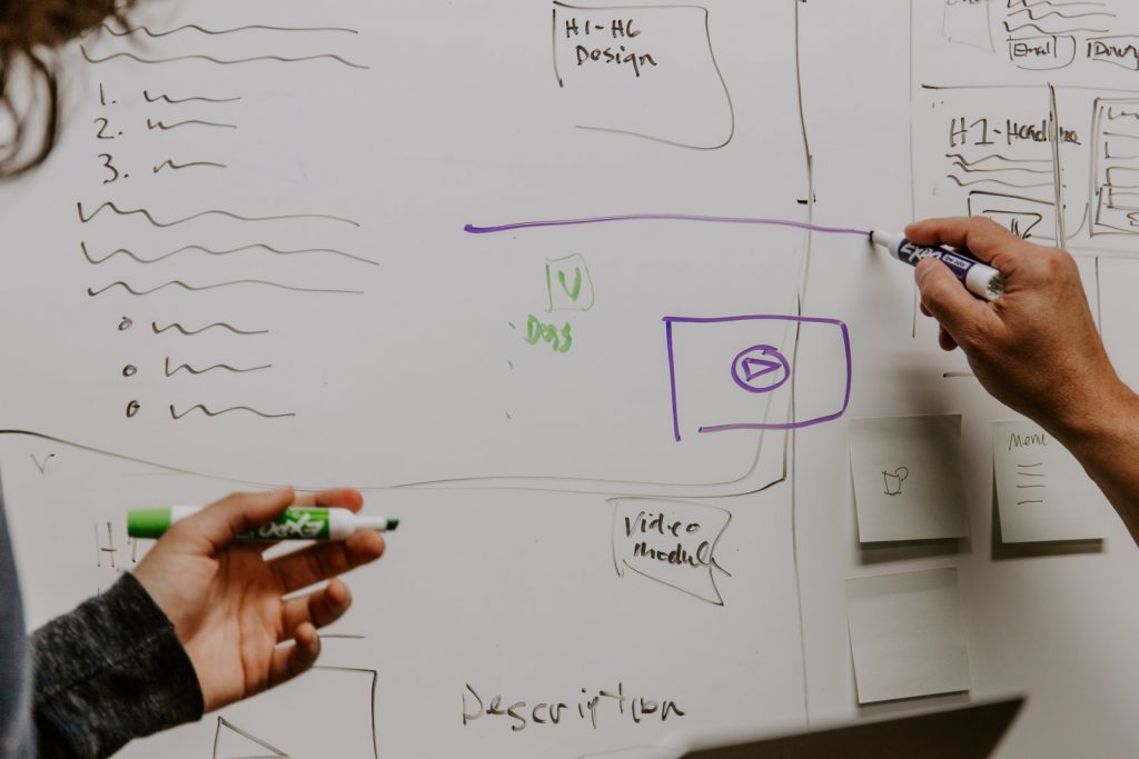 DevOps strategy two people drawing on whiteboard