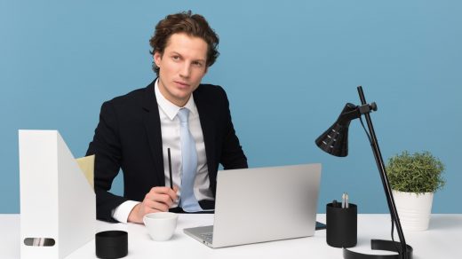 Hiring Your First Employee man sitting on chair beside laptop computer and teacup