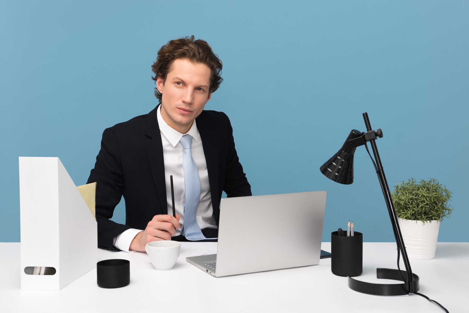 Hiring Your First Employee man sitting on chair beside laptop computer and teacup