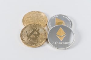 bitcoin ethereum four round silver-colored and gold-colored Bitcoins