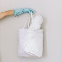 house cleaning business person holding white hand towel