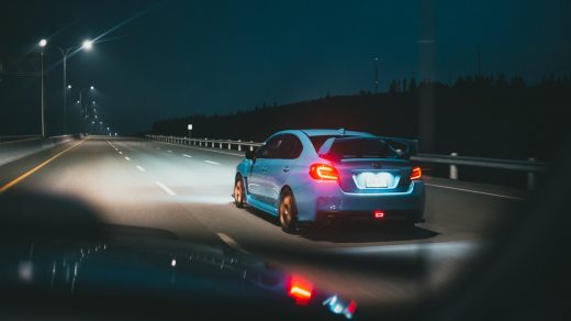 auto insurance white sedan on road during night time