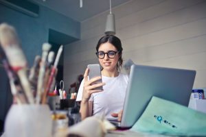CRM woman in white shirt using smartphone