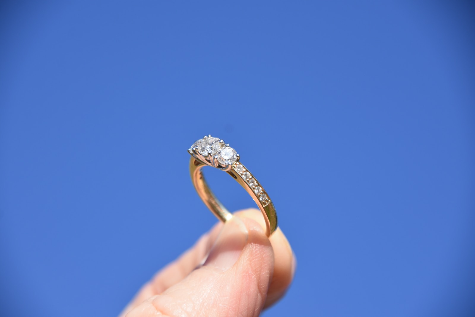 engagement ring person holding gold-colored ring