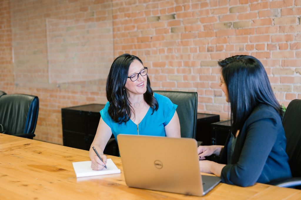 3 Tips to Improve Leadership Coaching Results for Your Business 1 Leadership Coaching - woman in teal t-shirt sitting beside woman in suit jacket