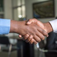 partnership two people shaking hands