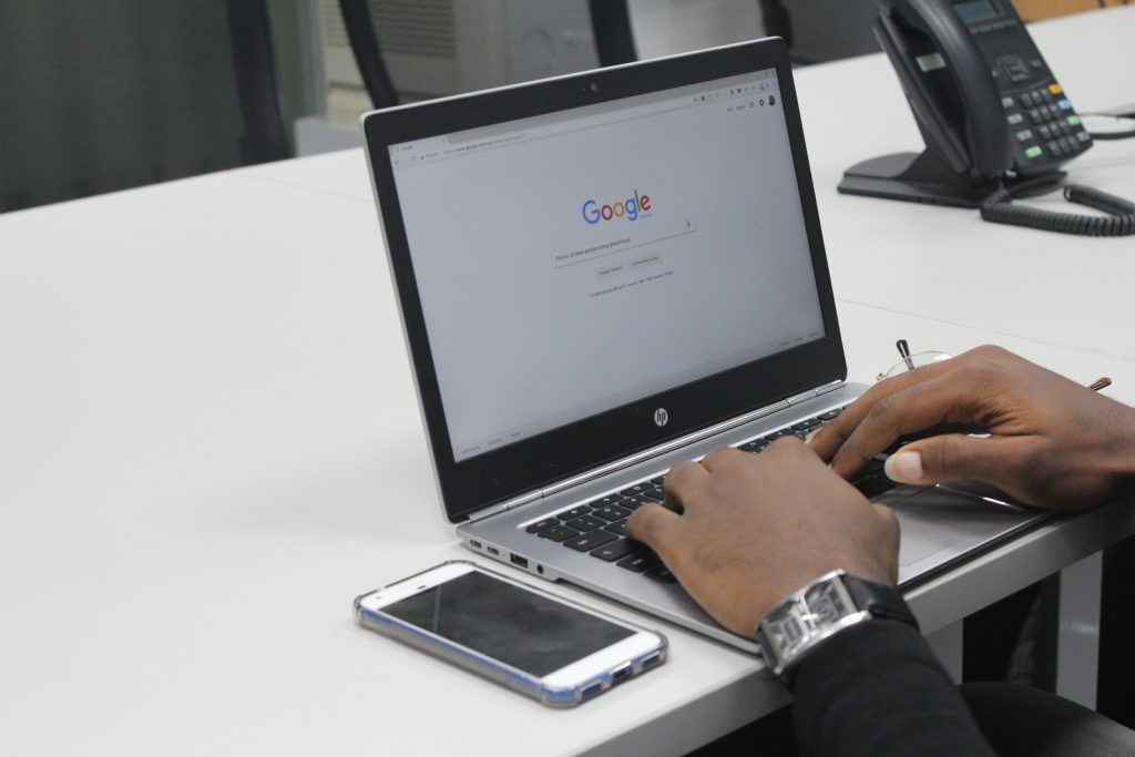 Internet Plan person typing on gray and black HP laptop