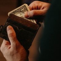 payday loans person getting 1 U.S. dollar banknote in wallet
