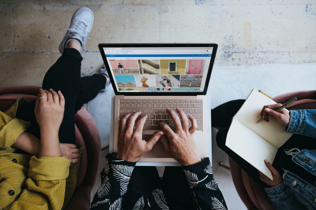 How to Apply the 4P tactics to Your Marketing Mix 1 marketing mix person using microsoft surface laptop on lap with two other people