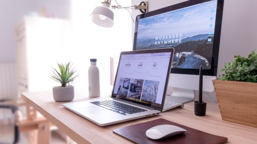 Optimize Your Website MacBook Pro on table beside white iMac and Magic Mouse