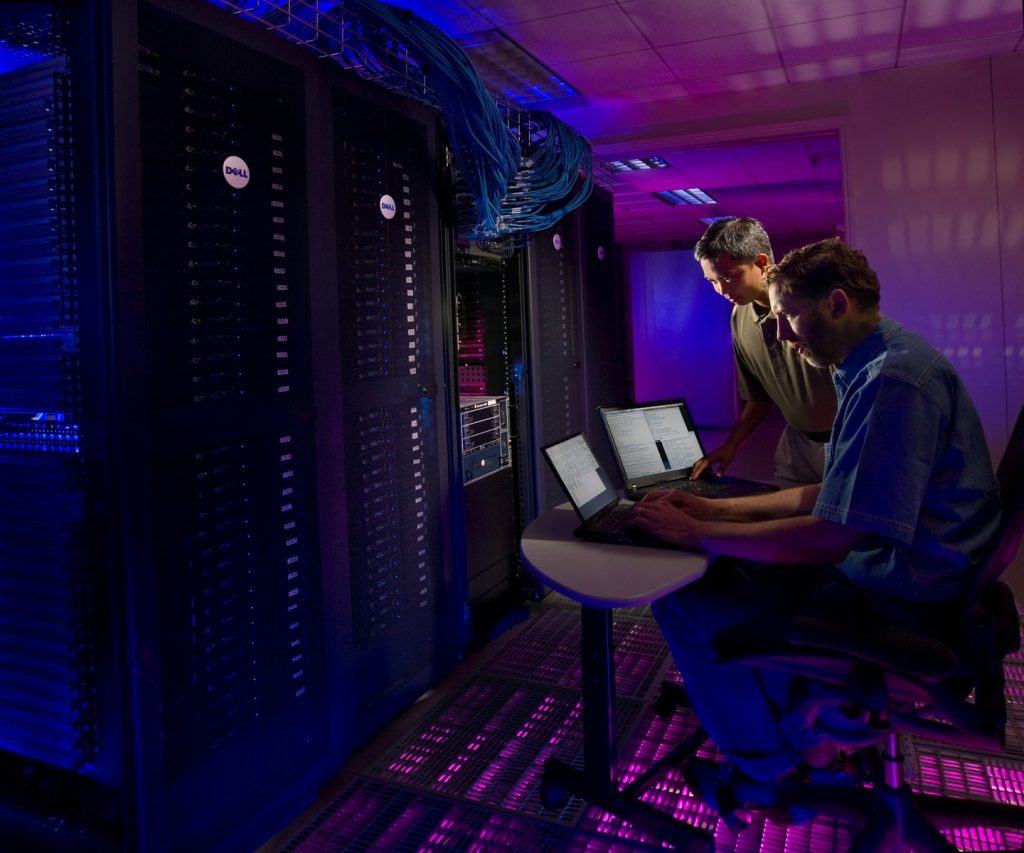 data room woman in blue long sleeve shirt sitting on black chair