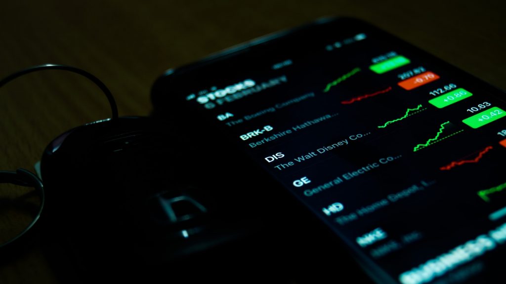 Tracking Your Portfolio while Ensuring Yields Across Your Assets 1 Portfolio tracking smartphone on brown wooden surface