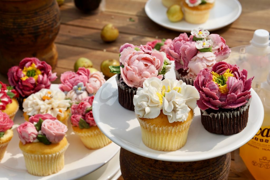 cupcake business pink and white flower bouquet on white ceramic plate