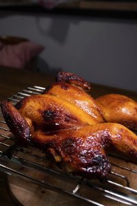 roasted chicken on black metal grill