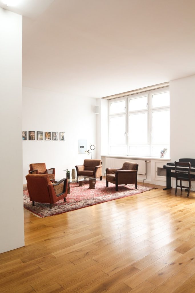 How to Choose Wooden Flooring 2 living room with brown wooden parquet floor and white wall