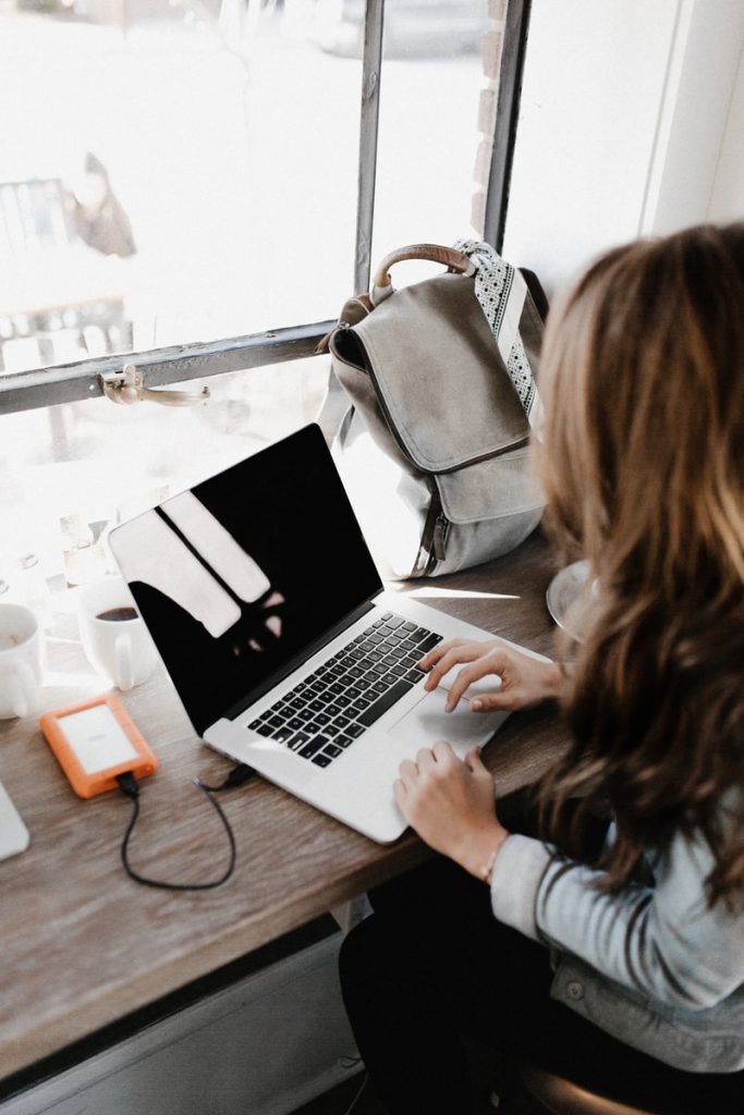 The Best Online Marketing Ideas for Your Small Businesses 1 girl wearing grey long-sleeved shirt using MacBook Pro on brown wooden table