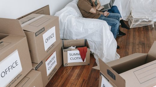 Couple Sitting On A Couch Near Brown Boxes