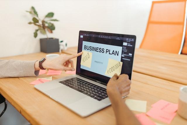 Two people analyzing a business plan.