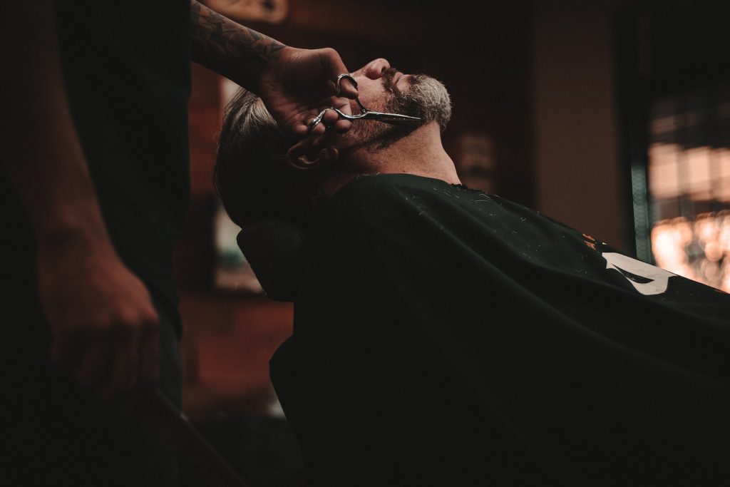 How to Easily Manage a Barbershop 1 man sitting on barber's chair