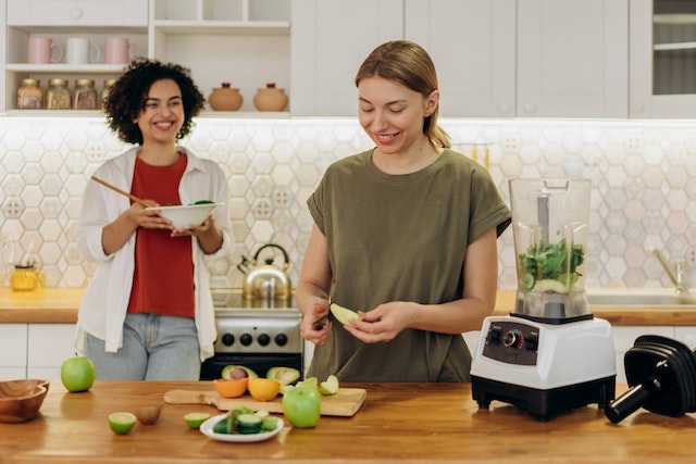 two happy women cooking