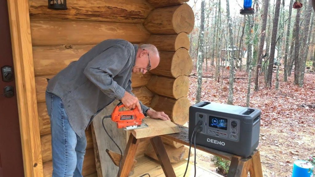 man cutting wood using a portable power station