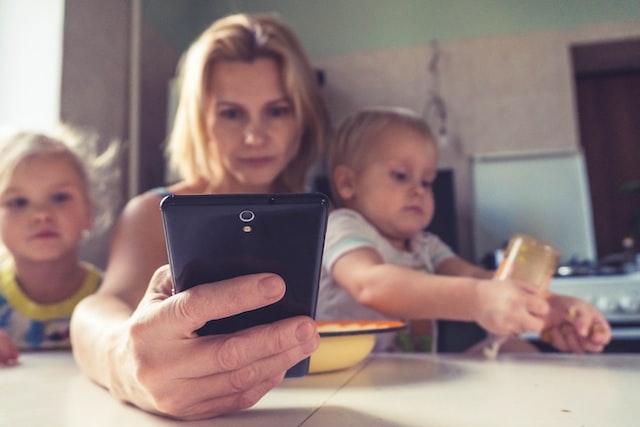 Best Jobs for Stay at Home Moms 1 mom looking at her phone