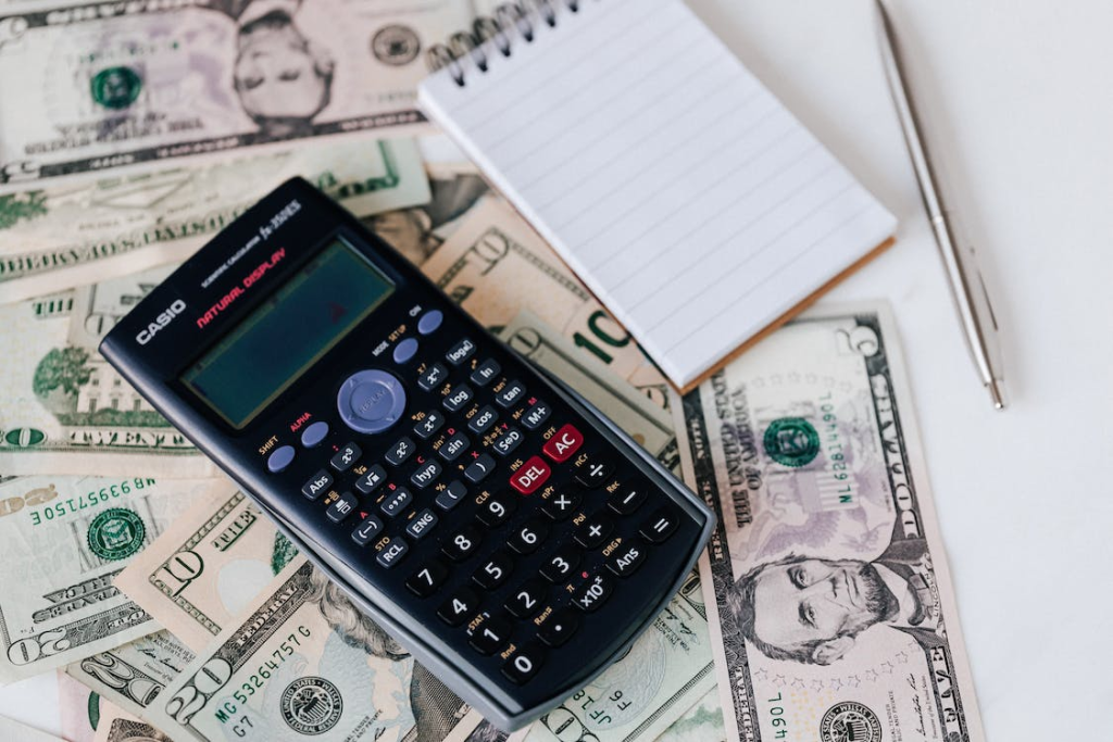 calculator and USD bills