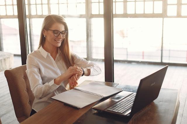 A female entrepreneur attending an online meeting and smiling.