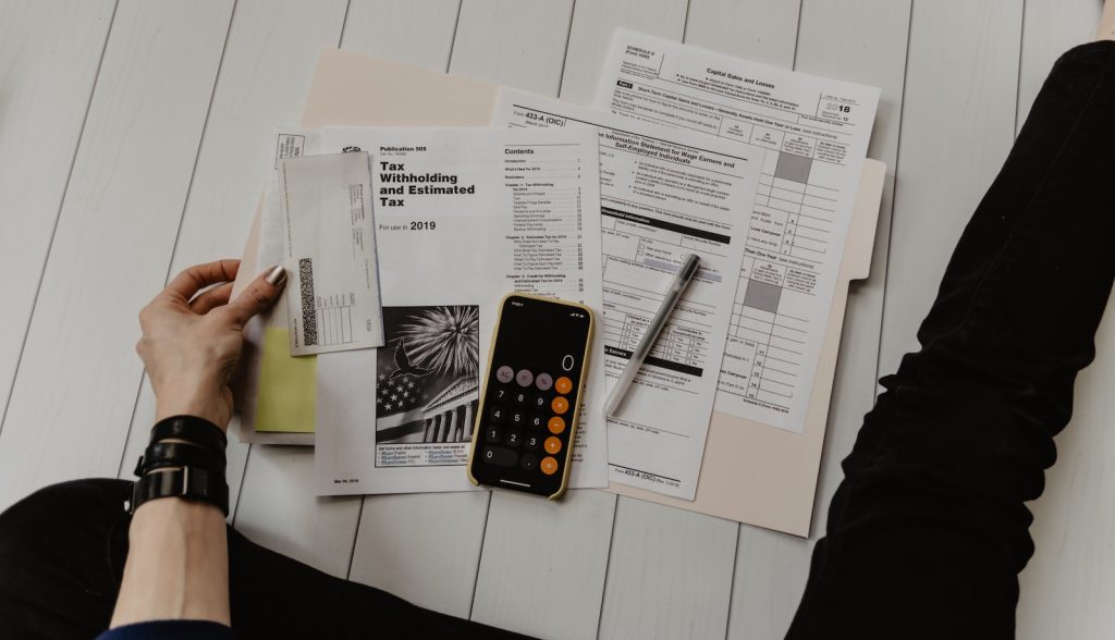 The Power of Tax-Deferred Growth: Annuities and Other Investment and Insurance Vehicles 6 person holding paper near pen and calculator