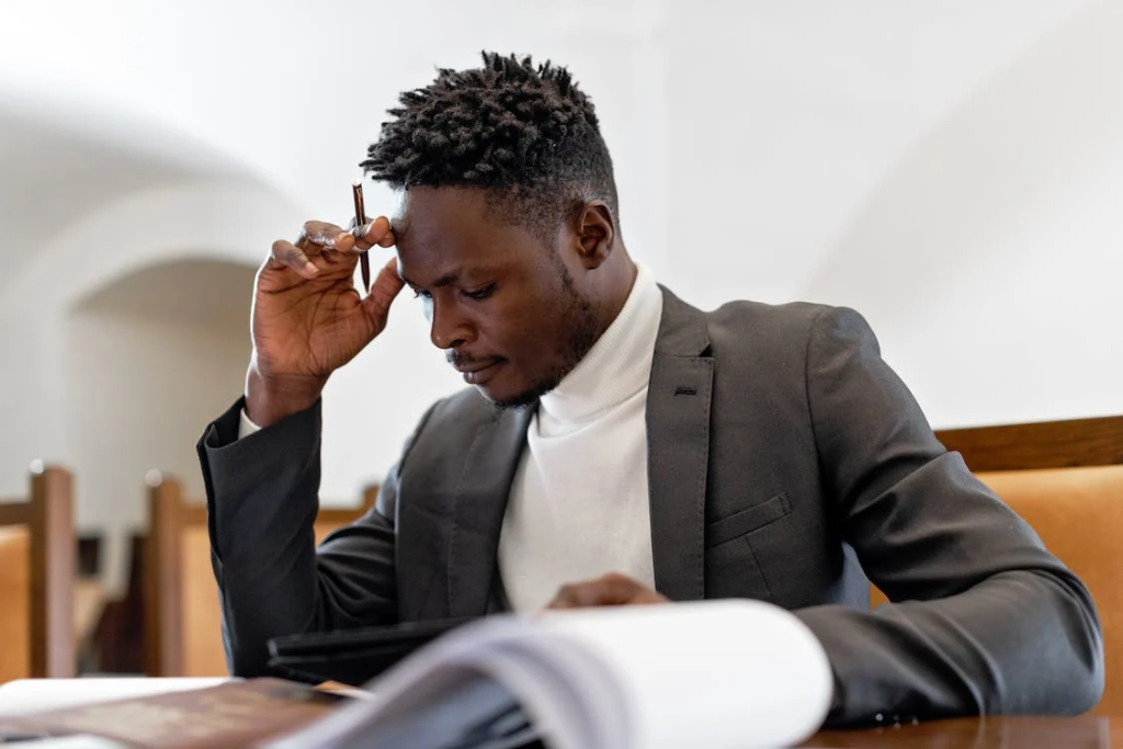 What You Need To Consider Before Buying a Business 1 man sitting in a table while thinking