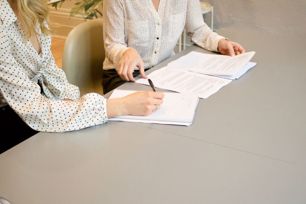 woman signing on white paper