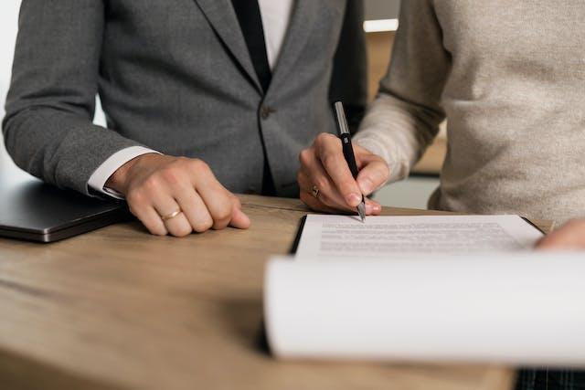 A person signing a paper.