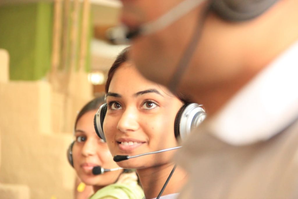 woman in black headphones holding black-and silver headphones