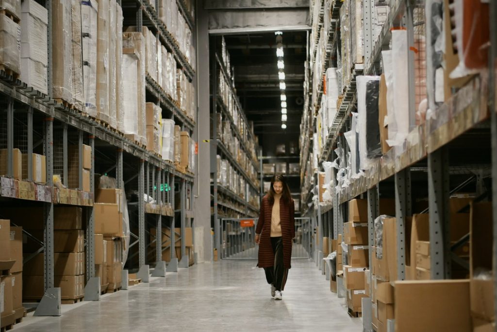 Warehousing- woman walking at the hallway