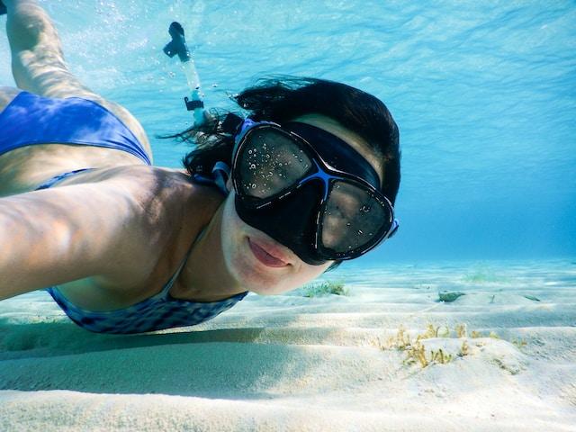 The Coastal Hotspots for Remote Work in Florida 3 Woman in a blue swimsuit with goggles underwater