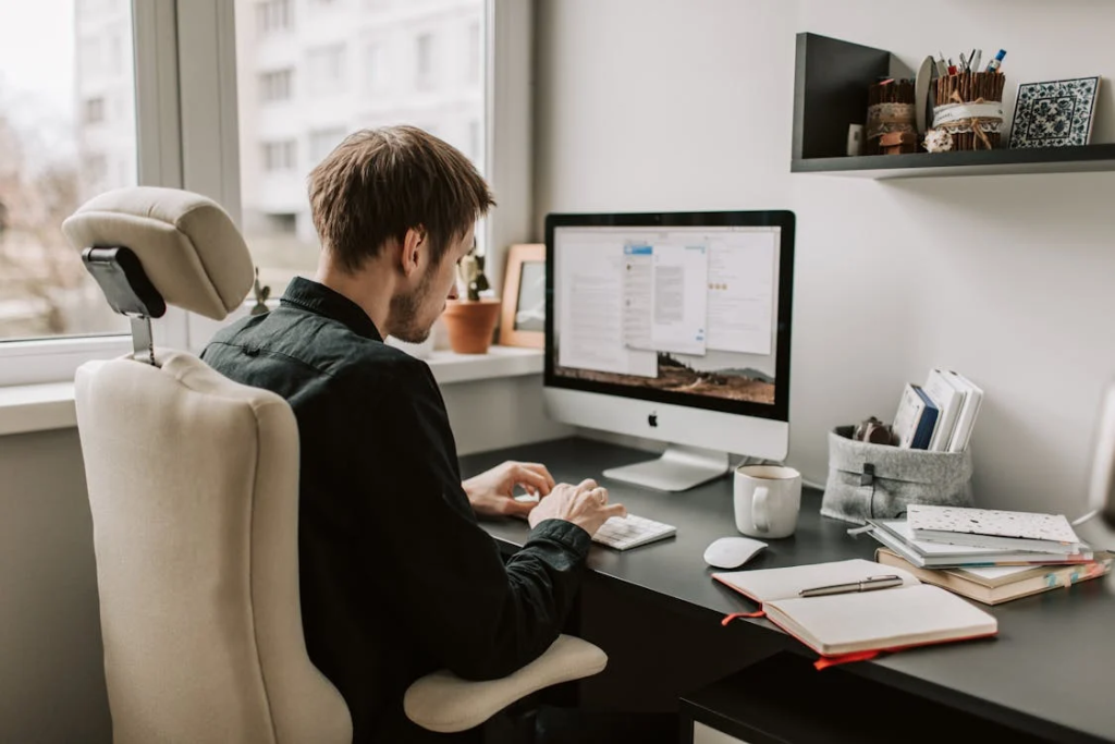 photo of man using a computer