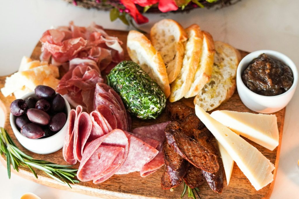 Charcuterie Board Recipes: Crafting the Perfect Spread 1 sliced meat with vegetable and bread on brown wooden chopping board