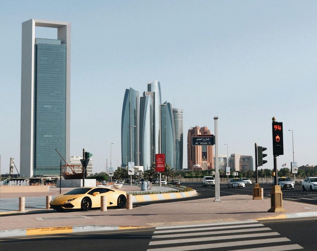 Abu Dhabi’s Free Zones: A Haven for Small Business Owners 1 An Abu Dhabi cityscape with cars passing