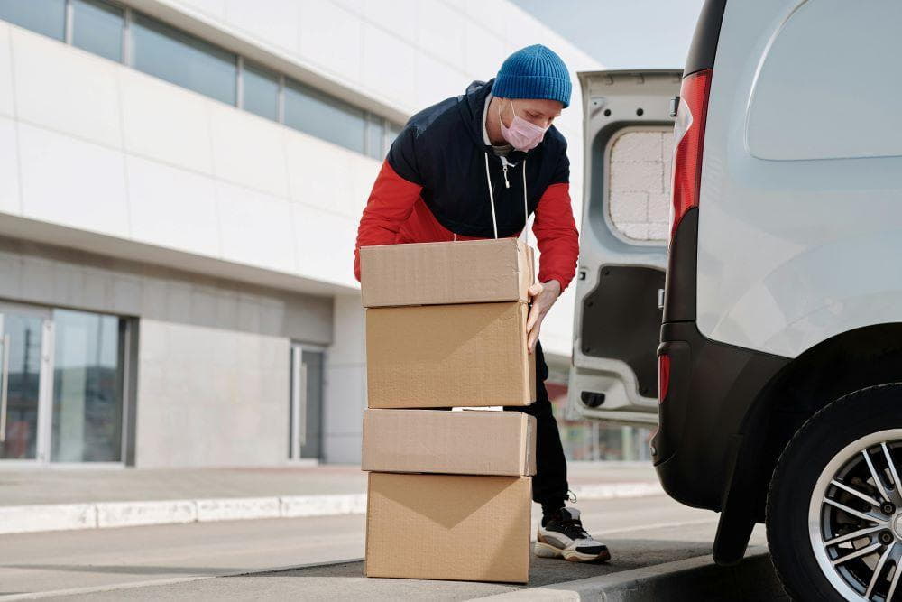 How to Successfully Relocate Your Small Business Within San Francisco 1 A man wearing a face mask and carrying boxes