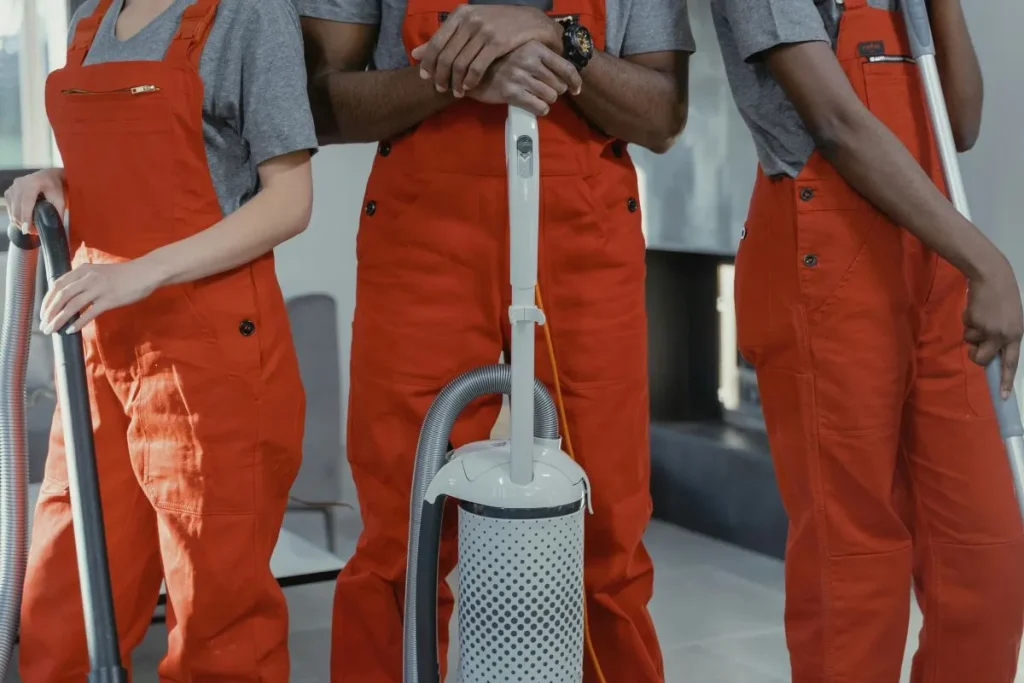 Shared Spaces, Shared Air: Why Multi-Tenant Businesses Must Prioritize Air Duct Cleaning 1 Professional cleaners wearing orange coveralls.