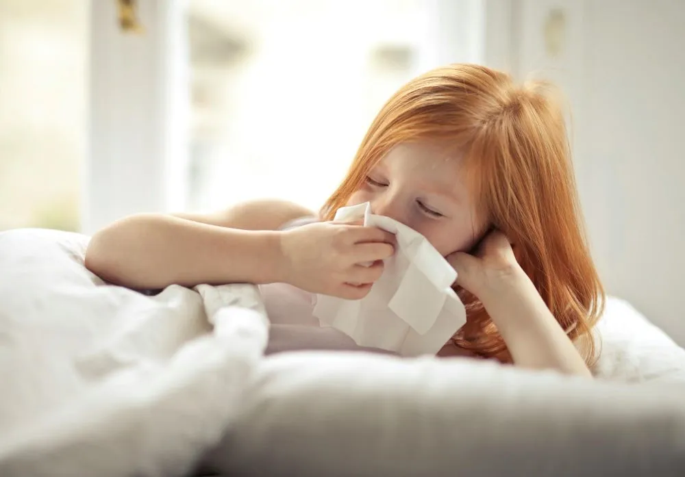 Shared Spaces, Shared Air: Why Multi-Tenant Businesses Must Prioritize Air Duct Cleaning 4 A young girl has an allergy and is feeling sick.