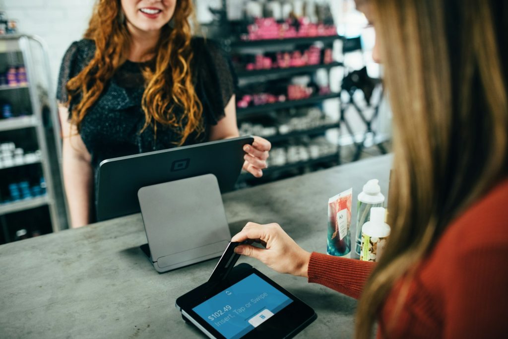 Design Tips That Turn HVAC Visitors Into Paying Customers 2 Paying Customers- woman holding magnetic card